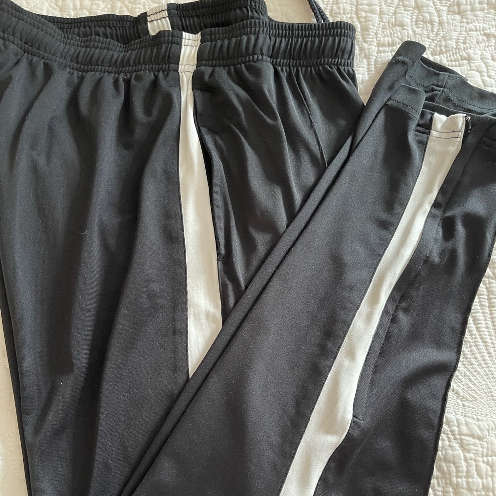 Reebok black with white line training pants.  Slim fit. Excellent shape